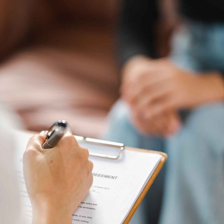 psychologist-making-notes-medical-history-while-understanding-problems-woman-patient-2